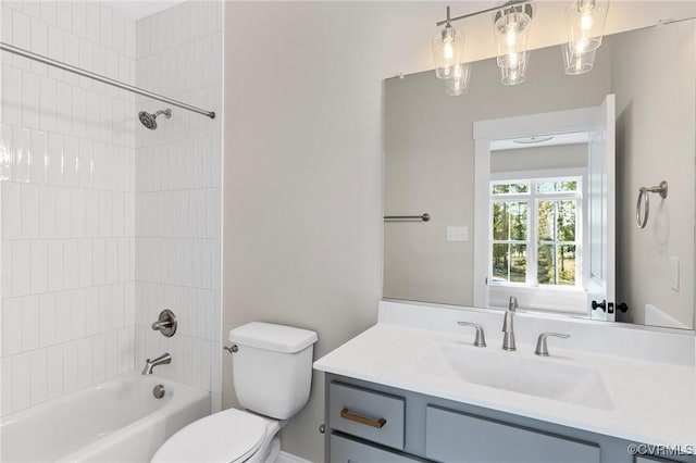 full bathroom with vanity, toilet, and tiled shower / bath