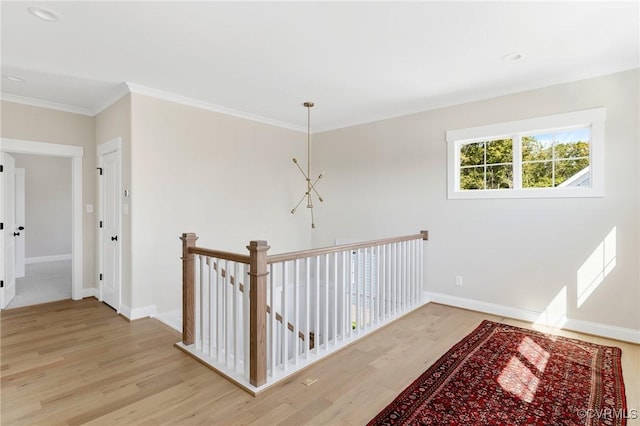 corridor with crown molding and light hardwood / wood-style flooring