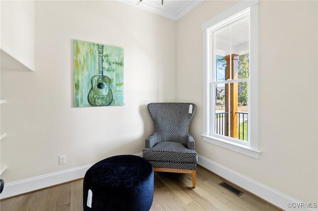 sitting room with wood-type flooring and a healthy amount of sunlight