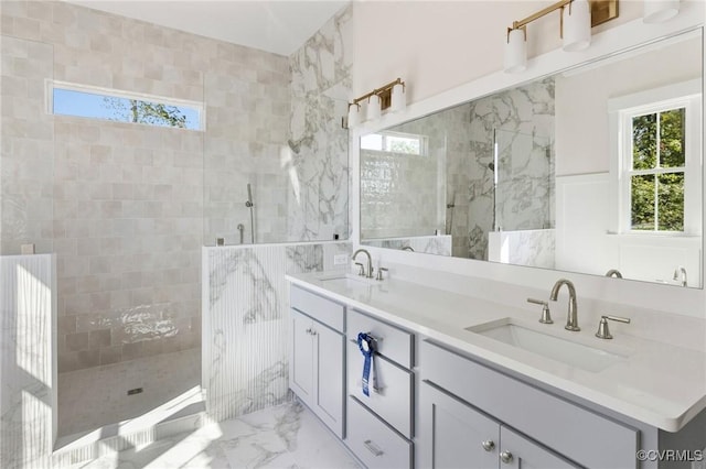 bathroom with vanity and a tile shower