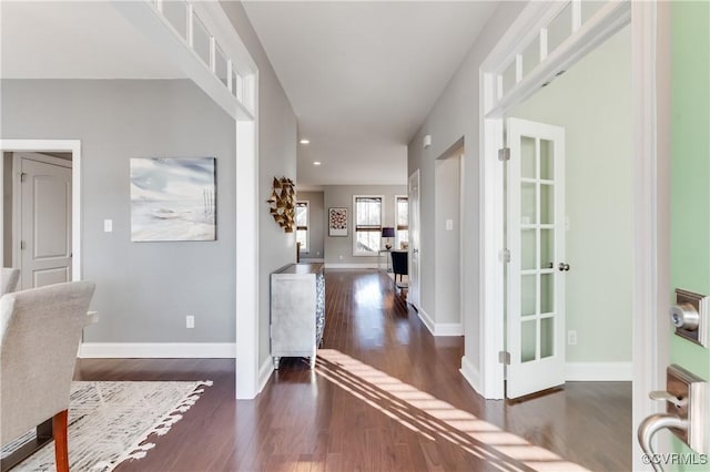 hallway with recessed lighting, wood finished floors, and baseboards