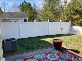 view of yard featuring fence private yard and central air condition unit