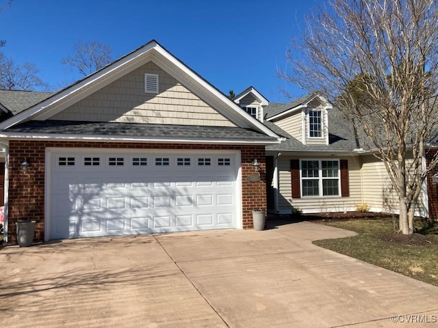 view of front of home with a garage, driveway, brick siding, and a shingled roof