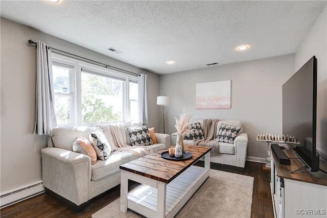 living area with a textured ceiling, visible vents, baseboard heating, and dark wood finished floors