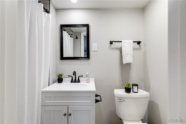 bathroom featuring toilet and vanity