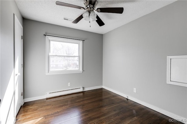 spare room with a textured ceiling, baseboards, baseboard heating, and wood finished floors