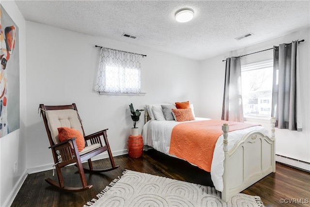 bedroom with dark wood-type flooring, multiple windows, and visible vents