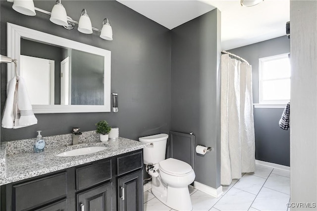 bathroom with marble finish floor, toilet, vanity, a shower with curtain, and baseboards