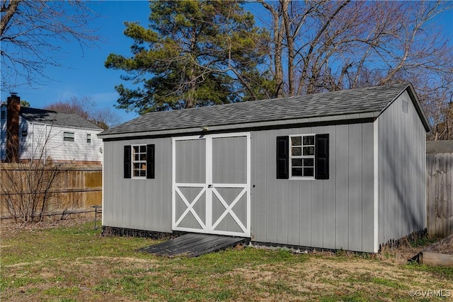 view of shed featuring fence