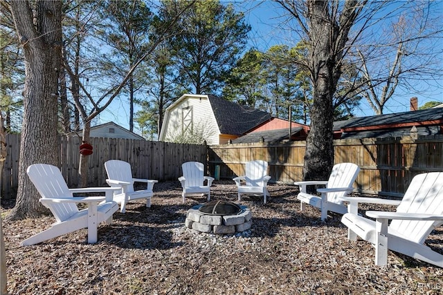 view of yard featuring an outdoor fire pit and a fenced backyard