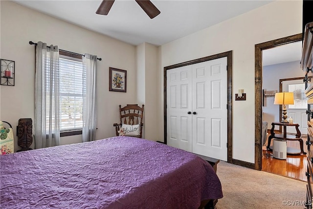 carpeted bedroom featuring a closet and ceiling fan