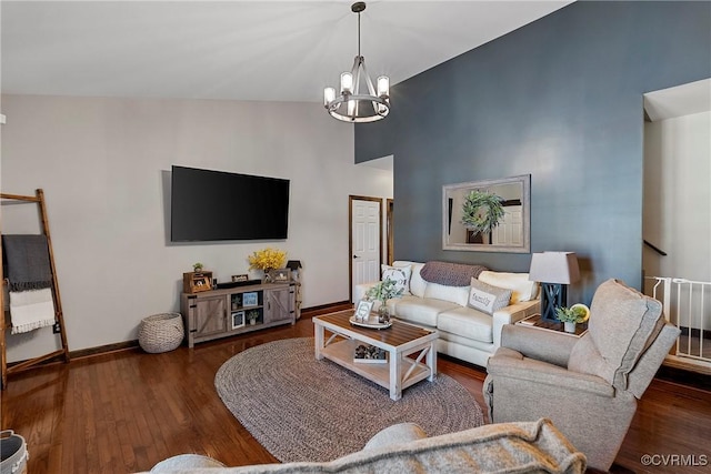 living room featuring high vaulted ceiling, dark hardwood / wood-style floors, and an inviting chandelier