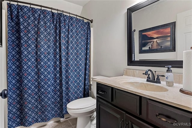 bathroom featuring vanity, tile patterned floors, and toilet