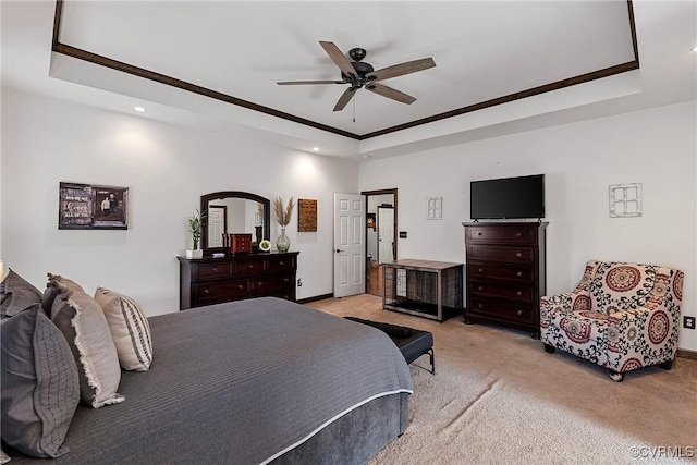 bedroom featuring ceiling fan, light colored carpet, and a raised ceiling