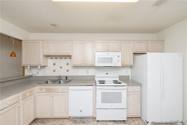 kitchen with sink, light brown cabinetry, and white appliances