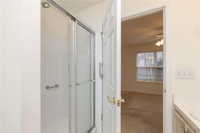 bathroom featuring an enclosed shower, vanity, and ceiling fan