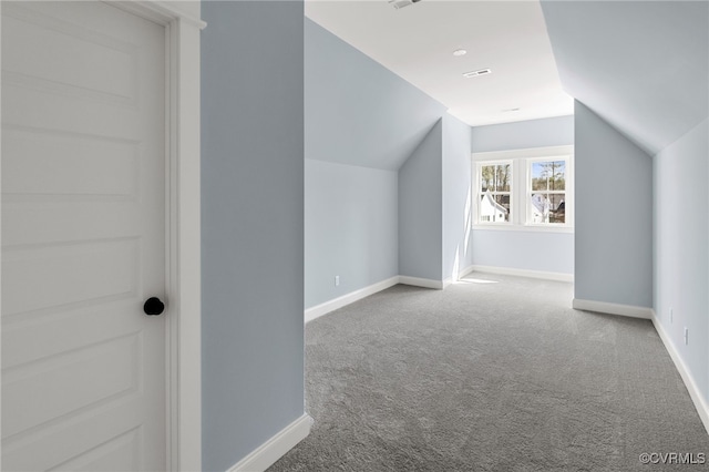 additional living space with vaulted ceiling and carpet flooring