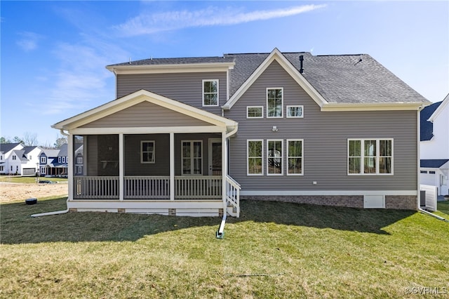 back of house featuring a lawn and a sunroom