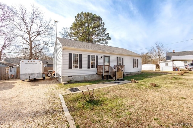 view of front of home featuring crawl space, driveway, fence, and a front lawn