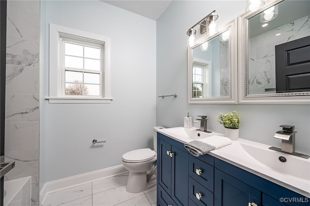 bathroom featuring vanity, a wealth of natural light, and toilet