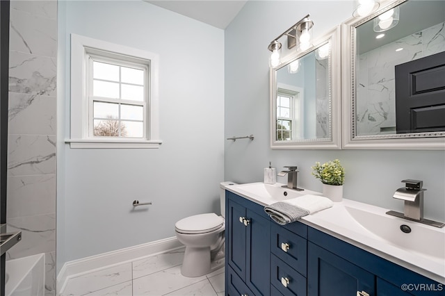 bathroom with a sink, a healthy amount of sunlight, baseboards, and marble finish floor