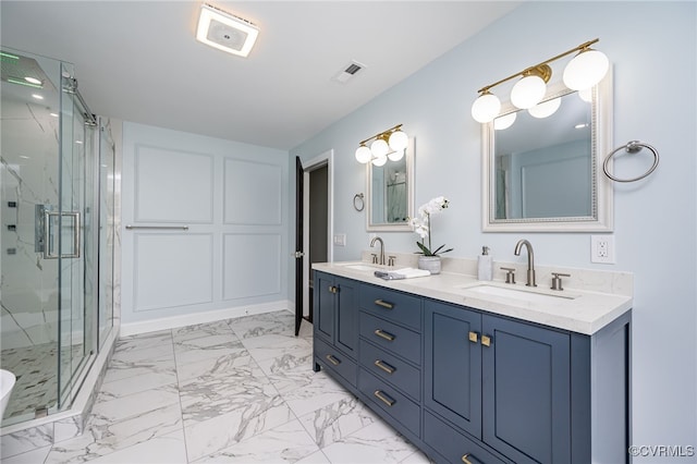 bathroom featuring a sink, a marble finish shower, double vanity, and marble finish floor