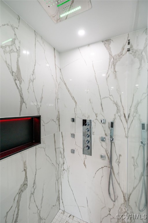 full bathroom featuring a marble finish shower