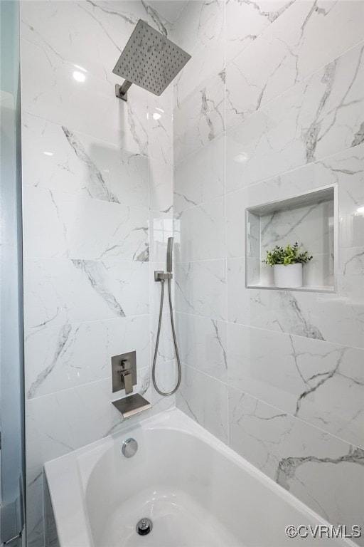 bathroom featuring tiled shower / bath