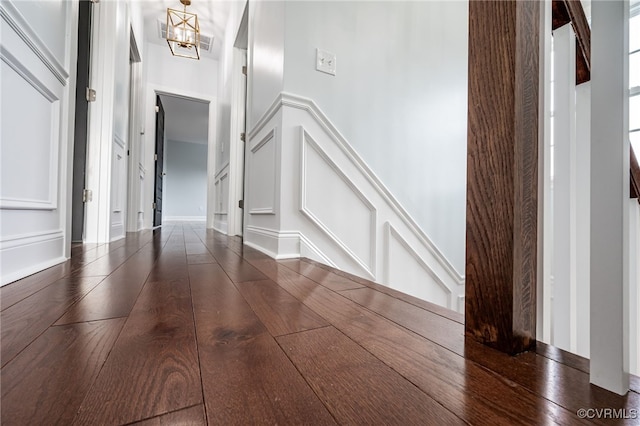 foyer featuring dark hardwood / wood-style flooring and a chandelier