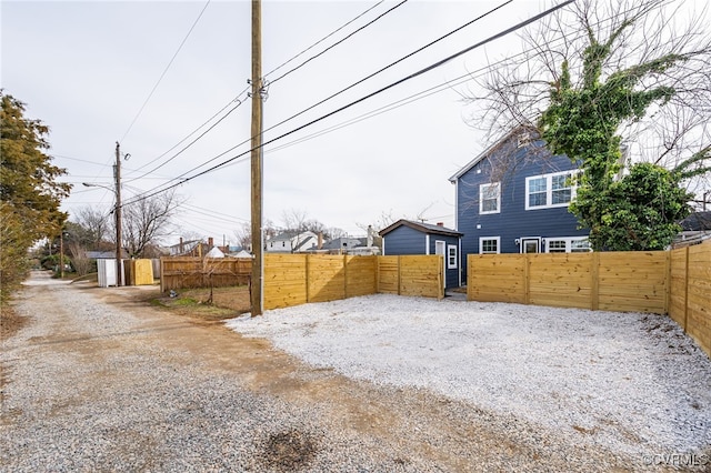 view of yard featuring a gate, fence private yard, and driveway
