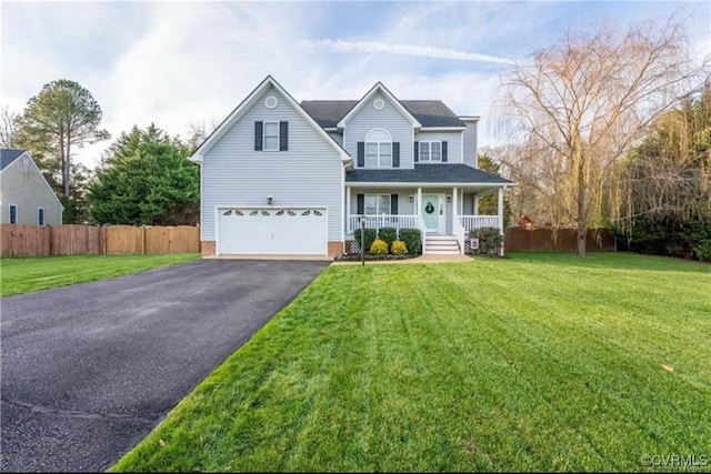 traditional-style house featuring driveway, a porch, an attached garage, and fence