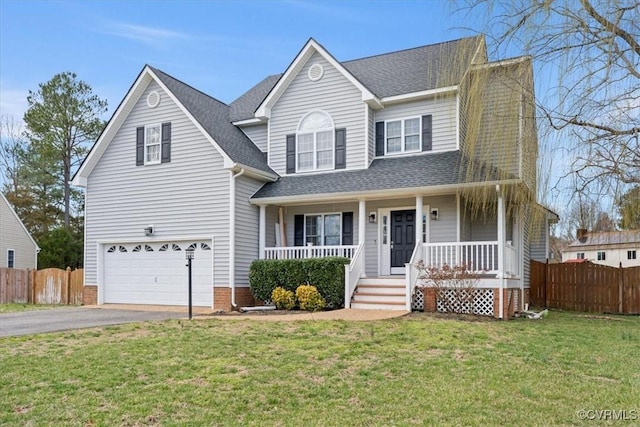 traditional home featuring a porch, an attached garage, fence, and aphalt driveway