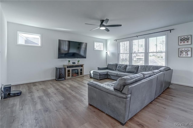 living room featuring ceiling fan and light hardwood / wood-style floors