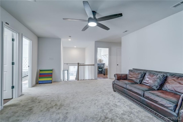 carpeted living room with ceiling fan