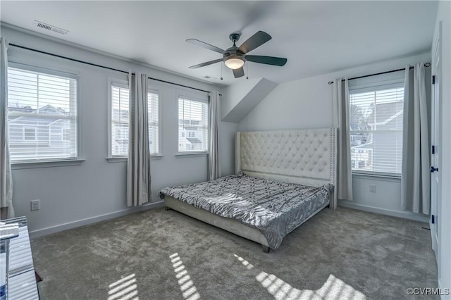 bedroom featuring multiple windows, dark carpet, and ceiling fan