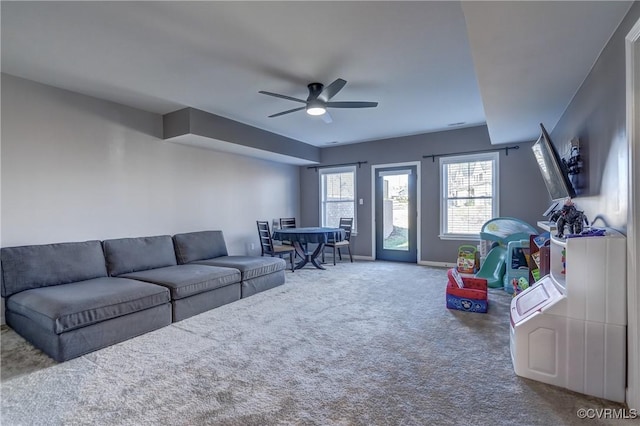 carpeted living room featuring ceiling fan