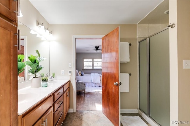 bathroom featuring double vanity, a stall shower, tile patterned flooring, and connected bathroom