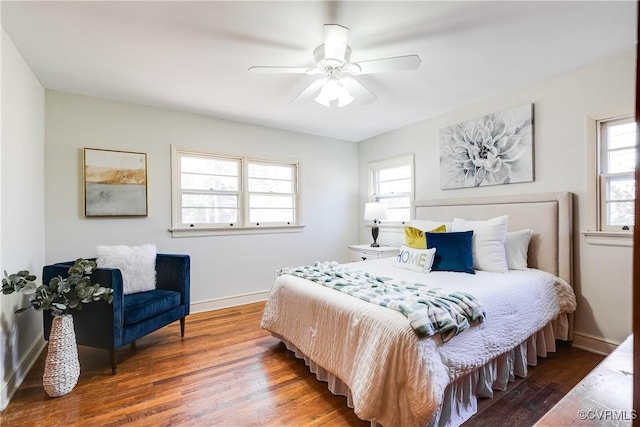 bedroom with ceiling fan, baseboards, and wood finished floors