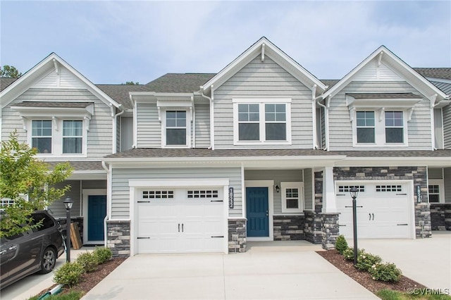 multi unit property with a garage and covered porch