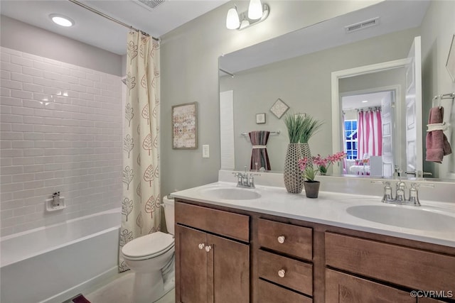 full bathroom with vanity, toilet, and shower / tub combo