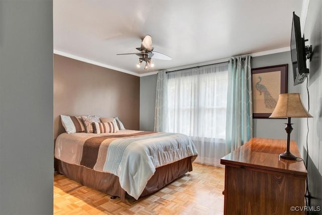 bedroom featuring ornamental molding, light parquet flooring, and ceiling fan