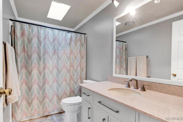 bathroom featuring toilet, vanity, a skylight, and ornamental molding