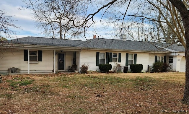 single story home with a chimney and a front yard