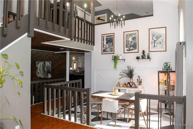 dining space featuring hardwood / wood-style flooring, sink, and an inviting chandelier