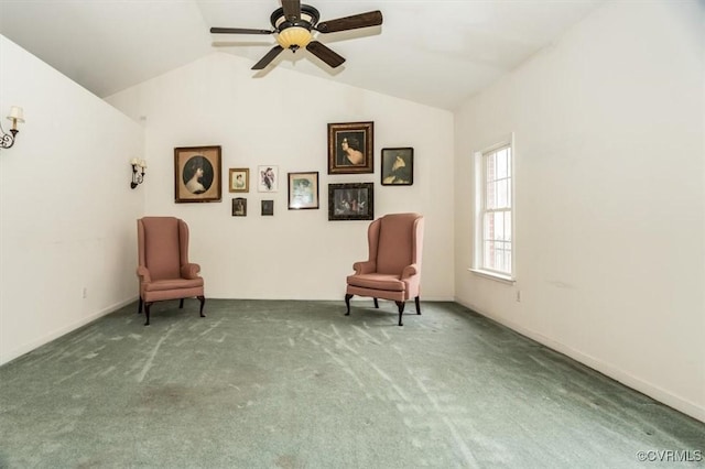 sitting room with lofted ceiling, light colored carpet, and ceiling fan