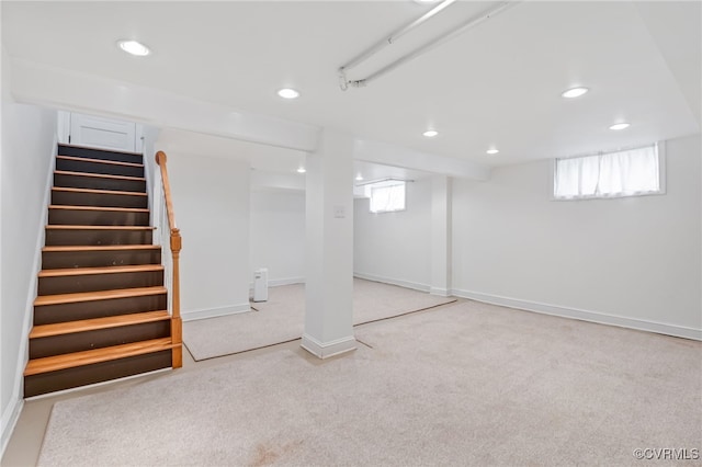 basement with carpet, stairs, a wealth of natural light, and recessed lighting