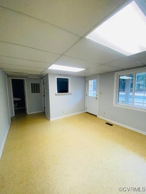 basement with a paneled ceiling