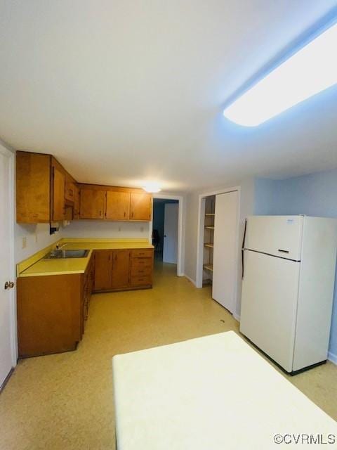 kitchen with white refrigerator and black electric cooktop