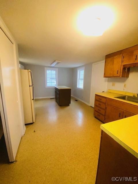 kitchen with sink and white fridge