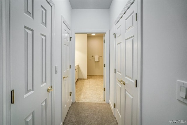 hallway with light colored carpet